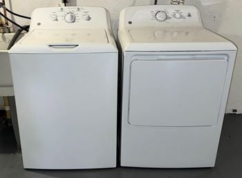 Two white washing machines side by side